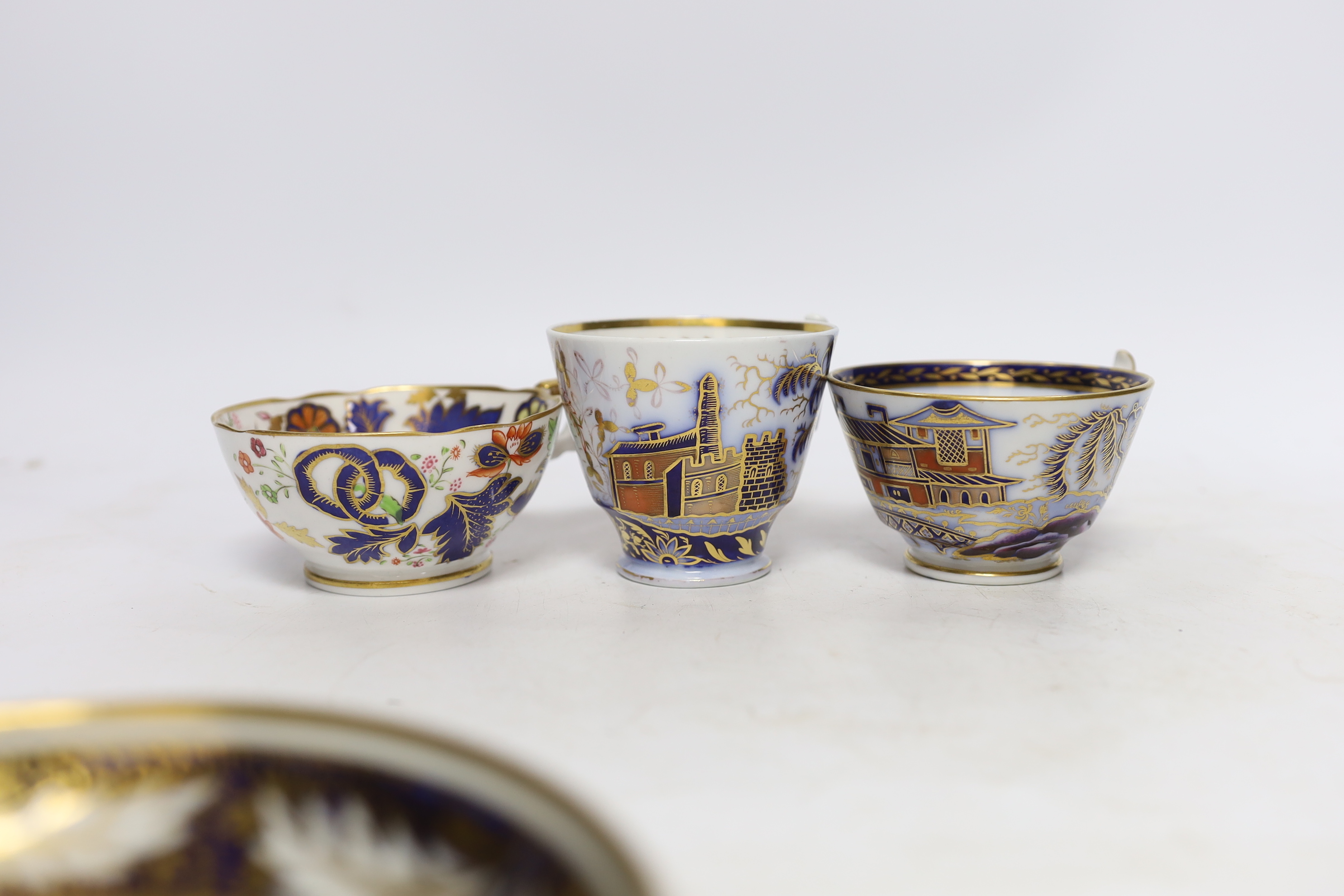 Eleven 1800-1820 English porcelain coffee cans and tea cups, including Imari pattern examples, one with matching saucer